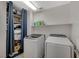 Convenient laundry room with washer, dryer, and shelving for storage, plus hanging space at 7856 Pyramid Peak St, Las Vegas, NV 89166