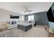 Cozy living room with an oversized sectional, stylish ottoman, and a large TV for entertainment at 7856 Pyramid Peak St, Las Vegas, NV 89166