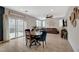 Cozy living area with a sliding glass door to the backyard, comfortable seating, and a ceiling fan at 7856 Pyramid Peak St, Las Vegas, NV 89166