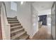 Carpeted staircase provides access to the upper level, open to the kitchen and living area at 7856 Pyramid Peak St, Las Vegas, NV 89166