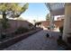 The backyard features a covered patio and a landscaped brick-paved area with a block wall perimeter at 916 Echo Beach Ave, North Las Vegas, NV 89086