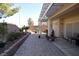 A beautifully landscaped backyard features a covered patio with a brick-paved area and attractive planters at 916 Echo Beach Ave, North Las Vegas, NV 89086