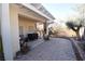 View of the backyard featuring a covered patio area, attractive landscaping, and a large, brick-paved area at 916 Echo Beach Ave, North Las Vegas, NV 89086