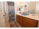 Bathroom featuring double sink vanity, framed mirrors, and shower/tub combo with curtain at 916 Echo Beach Ave, North Las Vegas, NV 89086