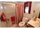 Bathroom featuring a shower, a sink, tile flooring, and red accents at 916 Echo Beach Ave, North Las Vegas, NV 89086