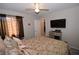Cozy bedroom with ceiling fan and mounted flatscreen TV at 916 Echo Beach Ave, North Las Vegas, NV 89086