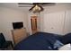 Bedroom with blue bedding, white closet, and a ceiling fan at 916 Echo Beach Ave, North Las Vegas, NV 89086
