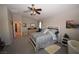 Spacious bedroom featuring contemporary furnishings, ceiling fan, and neutral carpet at 916 Echo Beach Ave, North Las Vegas, NV 89086
