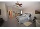 Spacious bedroom featuring contemporary furnishings, ceiling fan, and neutral carpet at 916 Echo Beach Ave, North Las Vegas, NV 89086