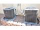 Two new air conditioning units are set side-by-side on gravel surrounded by a brick border at 916 Echo Beach Ave, North Las Vegas, NV 89086