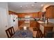 Eat-in kitchen with a center island, granite countertops, and wood cabinets at 916 Echo Beach Ave, North Las Vegas, NV 89086