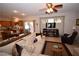 Open-concept living room with ceiling fan, kitchen access and three pane window at 916 Echo Beach Ave, North Las Vegas, NV 89086