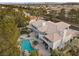 An aerial view showcases a luxury home, lush landscaping, and a stunning pool at 10 Innisbrook Ave, Las Vegas, NV 89113