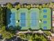 Overhead view of well-maintained tennis courts with new surface surrounded by trees and walkways at 10 Innisbrook Ave, Las Vegas, NV 89113