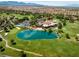 Expansive aerial view of a golf course community with a central lake and mountain backdrop at 10 Innisbrook Ave, Las Vegas, NV 89113