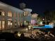 Night view of a luxurious backyard with a pool, elegant lighting, and a beautifully designed home exterior at 10 Innisbrook Ave, Las Vegas, NV 89113