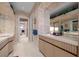 Bright bathroom showcasing a long stone countertop, sleek cabinetry, and a clear view into the adjoining areas at 10 Innisbrook Ave, Las Vegas, NV 89113