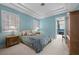 Comfortable bedroom with soft blue walls, two windows, a ceiling tray, and bedside tables with lamps at 10 Innisbrook Ave, Las Vegas, NV 89113