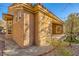 A view of the exterior showing stucco, tile roof, windows, and desert landscaping at 10013 Arbuckle Dr, Las Vegas, NV 89134