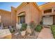 Welcoming front entrance with manicured landscaping, decorative pots, and a stone walkway at 10013 Arbuckle Dr, Las Vegas, NV 89134