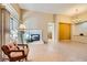 Bright living room featuring tile flooring, a cozy fireplace, and sliding glass doors to the outside at 10013 Arbuckle Dr, Las Vegas, NV 89134