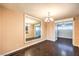 Dining room showing dark hardwood floors, chandelier and mirror at 1030 Tam O Shanter, Las Vegas, NV 89109