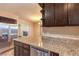 Kitchen featuring granite countertops, stainless steel appliances, and dark wood cabinetry at 1030 Tam O Shanter, Las Vegas, NV 89109