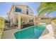 Spacious home featuring a sparkling pool, covered patio, and landscaped backyard at 10448 Niagara Falls Ln, Las Vegas, NV 89144
