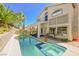 Inviting backyard featuring a pool, jacuzzi, lush plants and a covered patio at 10448 Niagara Falls Ln, Las Vegas, NV 89144