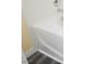 Corner of a white bathtub with shiny silver faucet and grey wood-look flooring at 10448 Niagara Falls Ln, Las Vegas, NV 89144