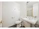 Bathroom featuring a pedestal sink and toilet; neutral color palette at 10448 Niagara Falls Ln, Las Vegas, NV 89144