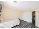 Bright bedroom features modern gray wood floors, fresh paint, and a spacious closet for ample storage at 10448 Niagara Falls Ln, Las Vegas, NV 89144