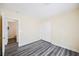 Comfortable bedroom with modern gray wood floors, a closet, and fresh paint with room for a bed and furniture at 10448 Niagara Falls Ln, Las Vegas, NV 89144