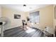 Light-filled bedroom features modern gray wood floors, a large window and plenty of space for a home office at 10448 Niagara Falls Ln, Las Vegas, NV 89144