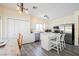 Well-lit kitchen with stainless steel appliances, a large island with seating, and a dining area at 10448 Niagara Falls Ln, Las Vegas, NV 89144