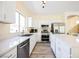 Bright modern kitchen features stainless steel appliances and an island with bar seating at 10448 Niagara Falls Ln, Las Vegas, NV 89144