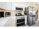 Well-equipped kitchen with stainless steel appliances and access to the staircase at 10448 Niagara Falls Ln, Las Vegas, NV 89144