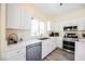 Bright kitchen featuring white cabinets, stainless steel appliances, and wood-look flooring at 10448 Niagara Falls Ln, Las Vegas, NV 89144