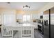 Well-appointed kitchen featuring stainless steel appliances, white cabinets, and a kitchen island with seating at 10448 Niagara Falls Ln, Las Vegas, NV 89144