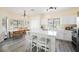 Bright eat-in kitchen with stainless steel appliances, modern lighting, and a large island with bar seating at 10448 Niagara Falls Ln, Las Vegas, NV 89144