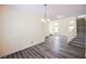 Open floorplan living room with wood-look flooring and staircase at 10448 Niagara Falls Ln, Las Vegas, NV 89144