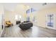 Living room with vaulted ceilings, fireplace, and modern gray wood-look floors at 10448 Niagara Falls Ln, Las Vegas, NV 89144
