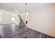 Open floorplan with wood-look flooring, staircase, and ample natural light at 10448 Niagara Falls Ln, Las Vegas, NV 89144