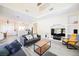 Open-concept living room with modern decor, a large TV, and a view into the kitchen at 10448 Niagara Falls Ln, Las Vegas, NV 89144