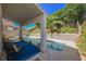 Inviting covered patio overlooking a sparkling pool and lush landscaped backyard at 10448 Niagara Falls Ln, Las Vegas, NV 89144