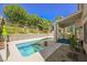 Tranquil pool and spa surrounded by lush landscaping and a covered patio at 10448 Niagara Falls Ln, Las Vegas, NV 89144