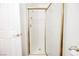 Shower featuring decorative glass door, tile surround, and gold trim at 10448 Niagara Falls Ln, Las Vegas, NV 89144