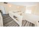 Staircase landing with wood-look floors, white banister, and neutral walls at 10448 Niagara Falls Ln, Las Vegas, NV 89144