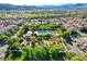 Aerial view of community pool and clubhouse surrounded by lush landscaping at 11428 Belmont Lake Dr # 104, Las Vegas, NV 89135