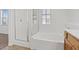 Bright bathroom with a large soaking tub and a separate glass-enclosed shower at 11428 Belmont Lake Dr # 104, Las Vegas, NV 89135
